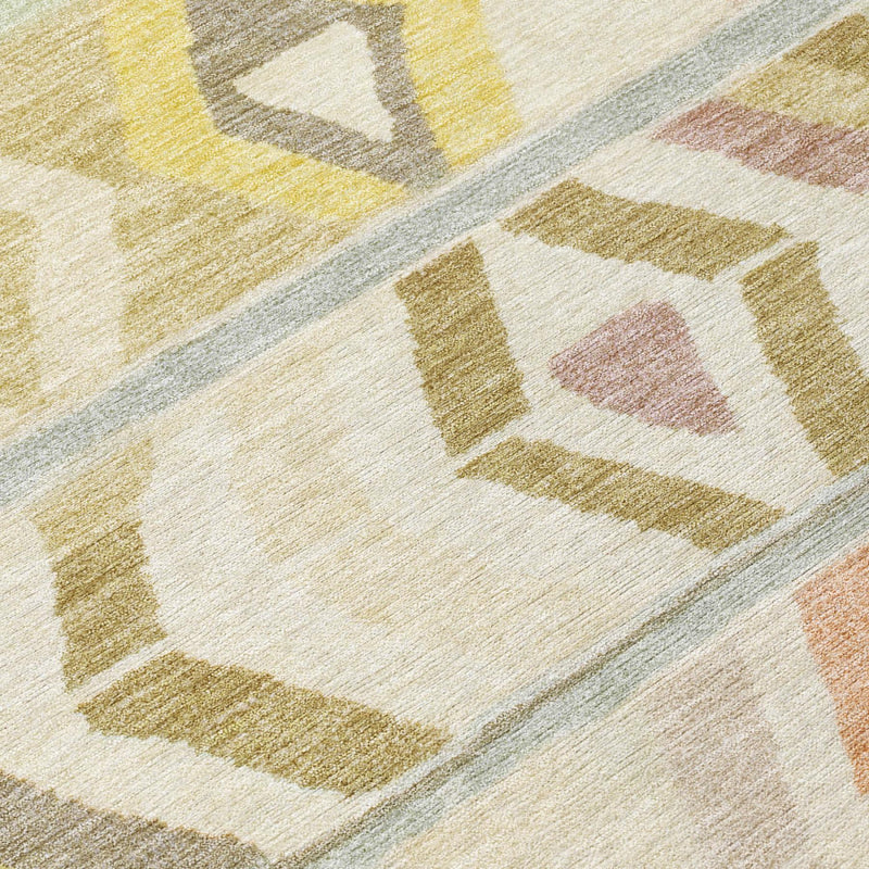 Close-up of woven-look tribal rug with cream ground and muted yellow, brown accents