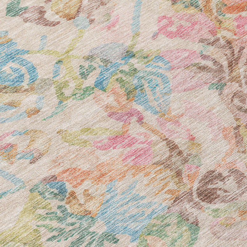 Close-up floral area rug fabric texture with pastel pink, blue, tan and cream pattern