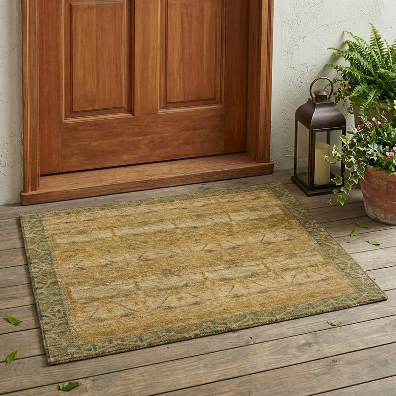 Area rug with distressed beige field and teal diamond pattern, flat weave