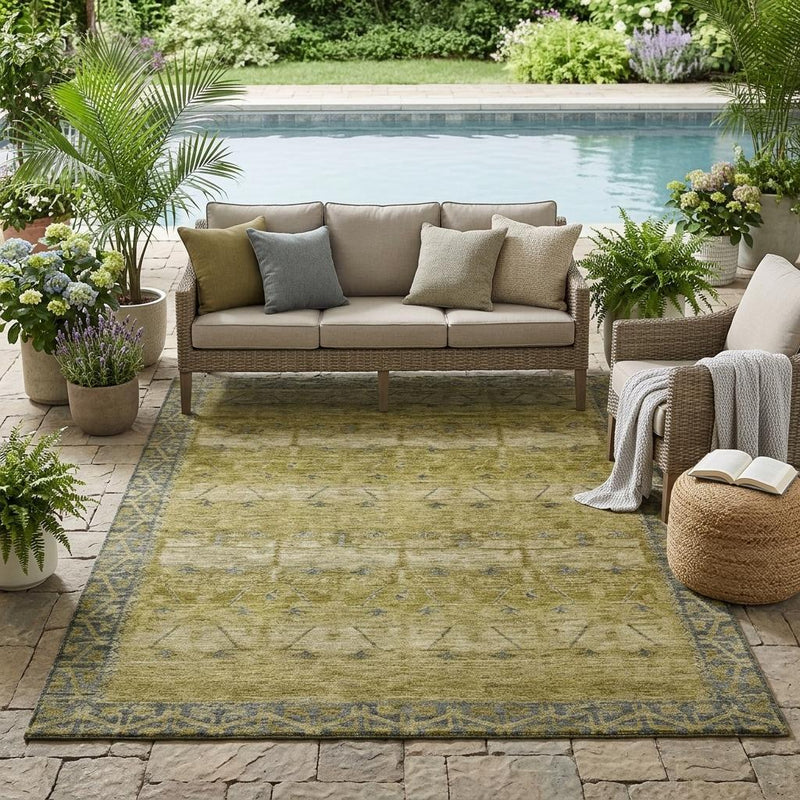 Olive and blue tribal washable area rug with bordered design in an outdoor seating area.