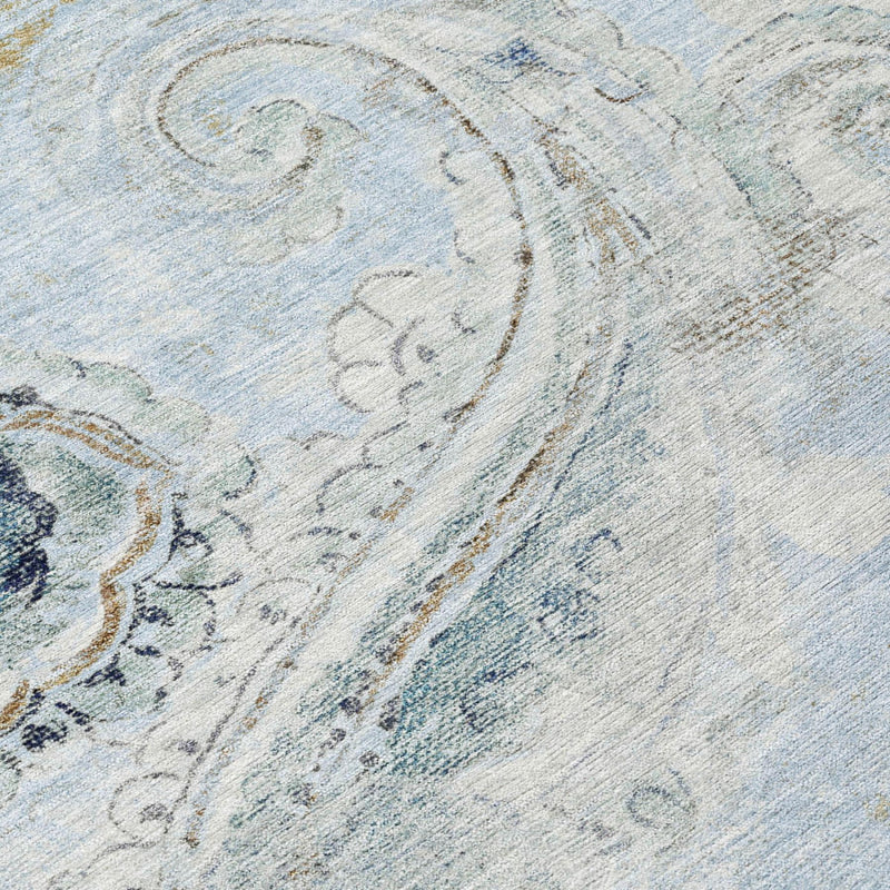 Close-up of round rug showing sky blue and blue ornate paisley swirls