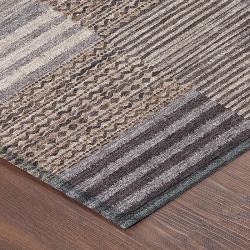 Gray and brown area rug with horizontal striped border and patchwork design