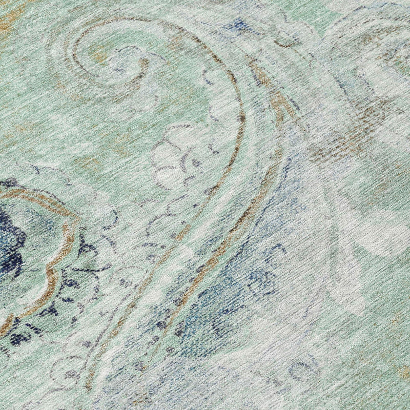 Aqua and teal paisley area rug surface detail with faded blue and tan accents