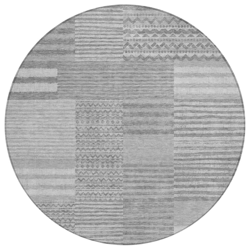Round gray and silver rug with mixed stripe pattern and geometric motif blocks.