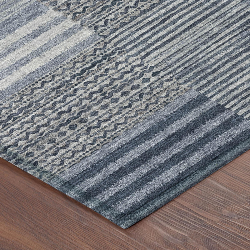 Blue and gray striped area rug corner with dense woven pattern texture