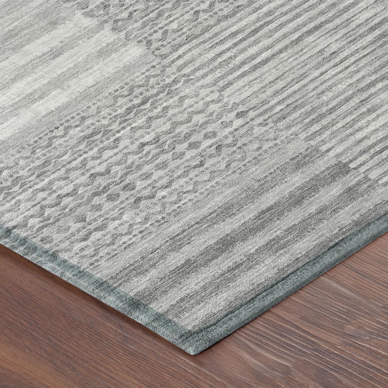 Gray and silver area rug corner with fine striped texture and subtle motif pattern