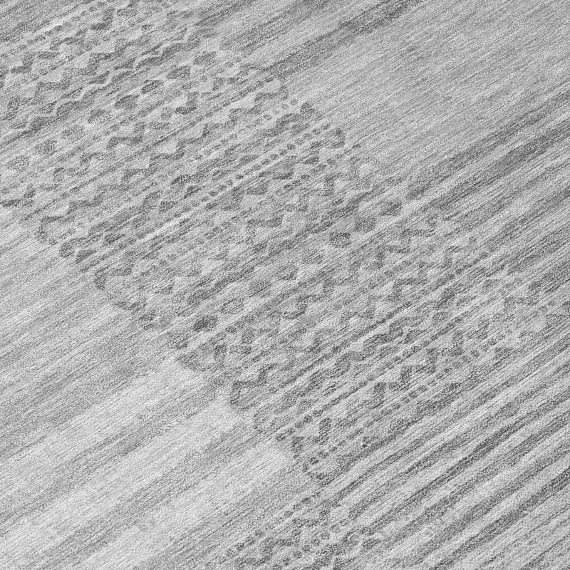 Gray and silver textured area rug surface with horizontal and abstract stripe motifs