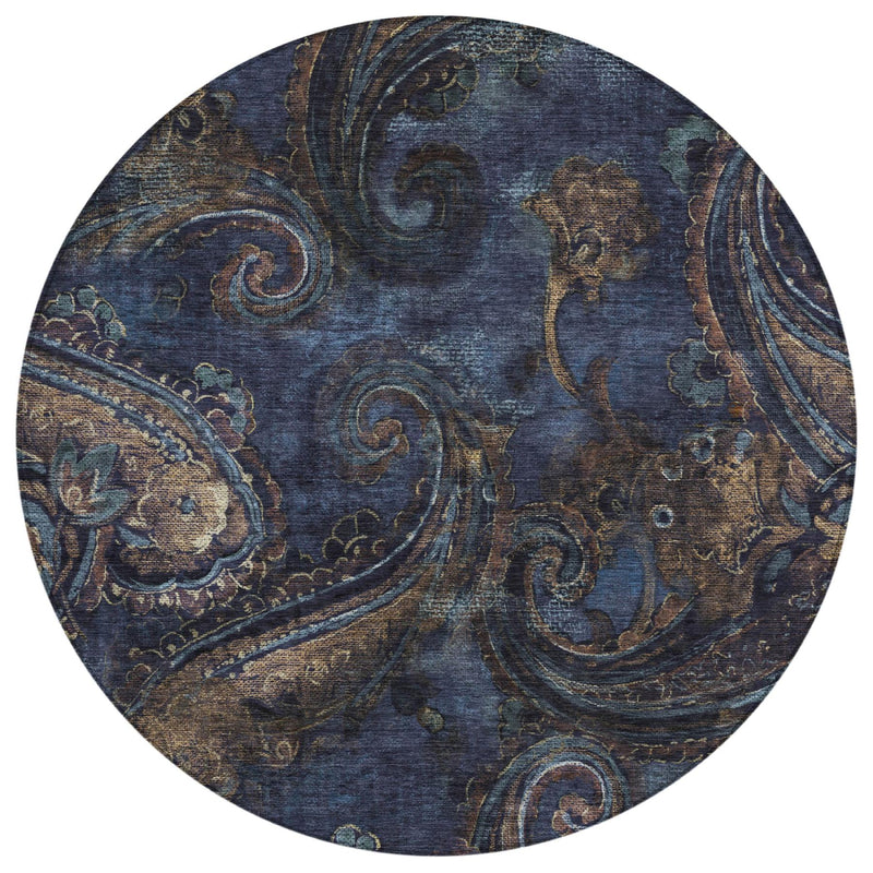 Round paisley area rug in navy blue with ornate beige and teal scroll pattern.