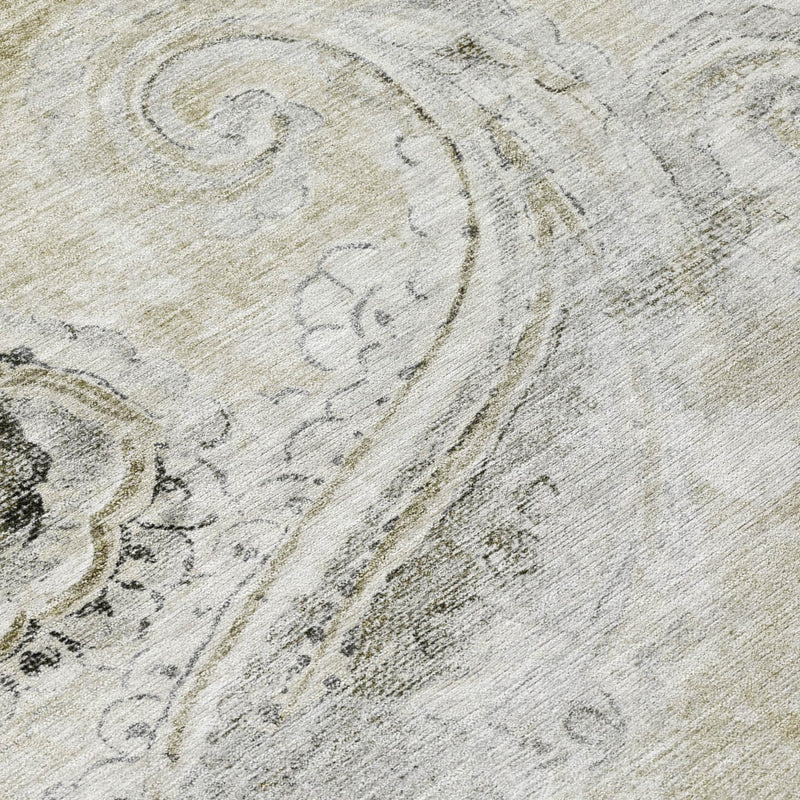 Close-up khaki rug texture with faded paisley outlines in dark gray