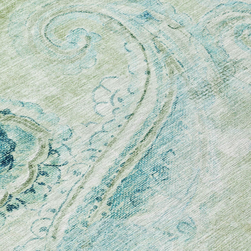 Sage green area rug with paisley medallion pattern in blue and teal accents