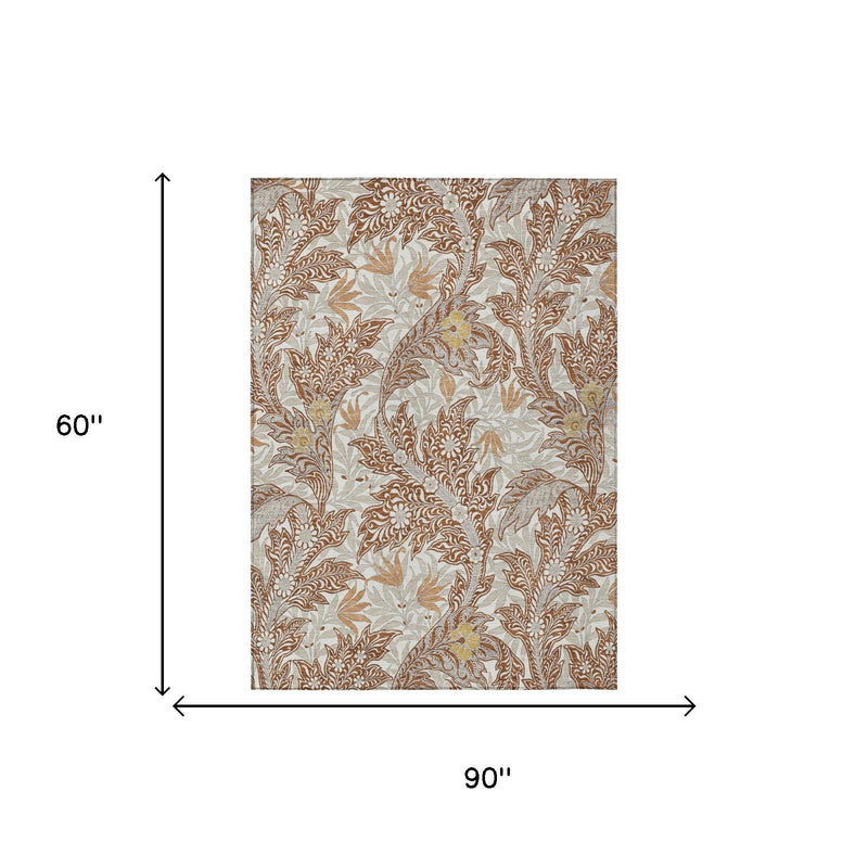 Rectangular 5x8 area rug, 60" by 90", botanical leaf pattern in orange and khaki