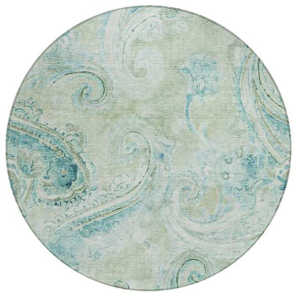 Round indoor/outdoor area rug with sage green base and blue paisley pattern
