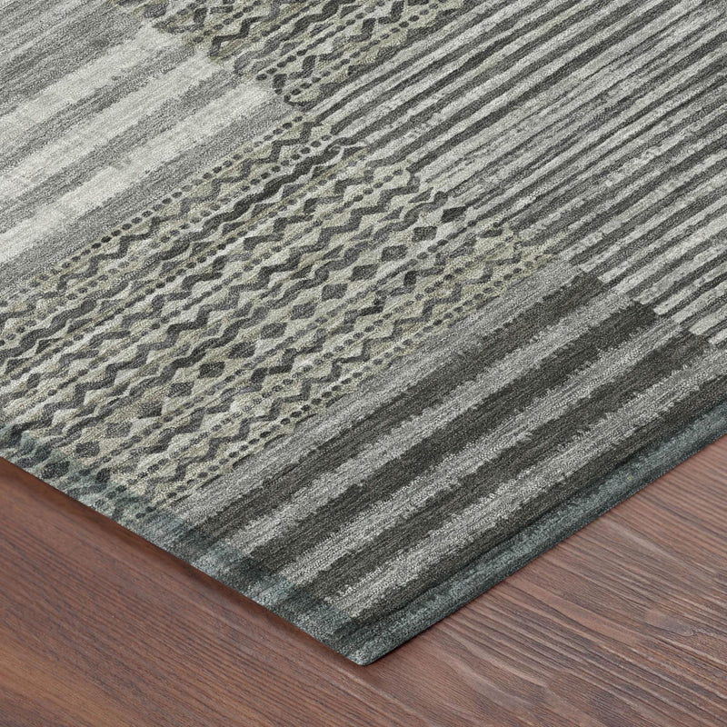 Close-up of pewter-gray striped area rug with dotted geometric motif