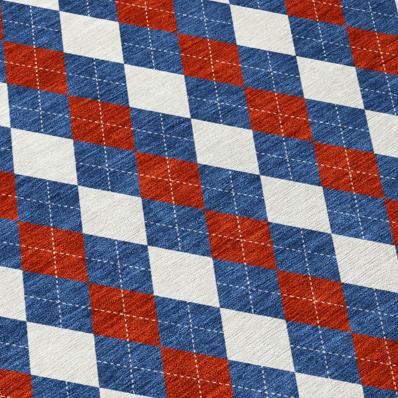 Round area rug close-up with blue, ivory and rust checkered diamond pattern