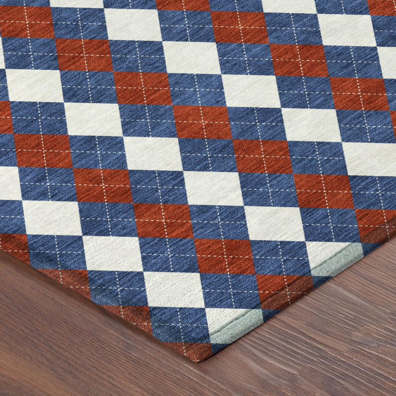 Corner view of round area rug with blue, ivory and rust diamond geometric pattern