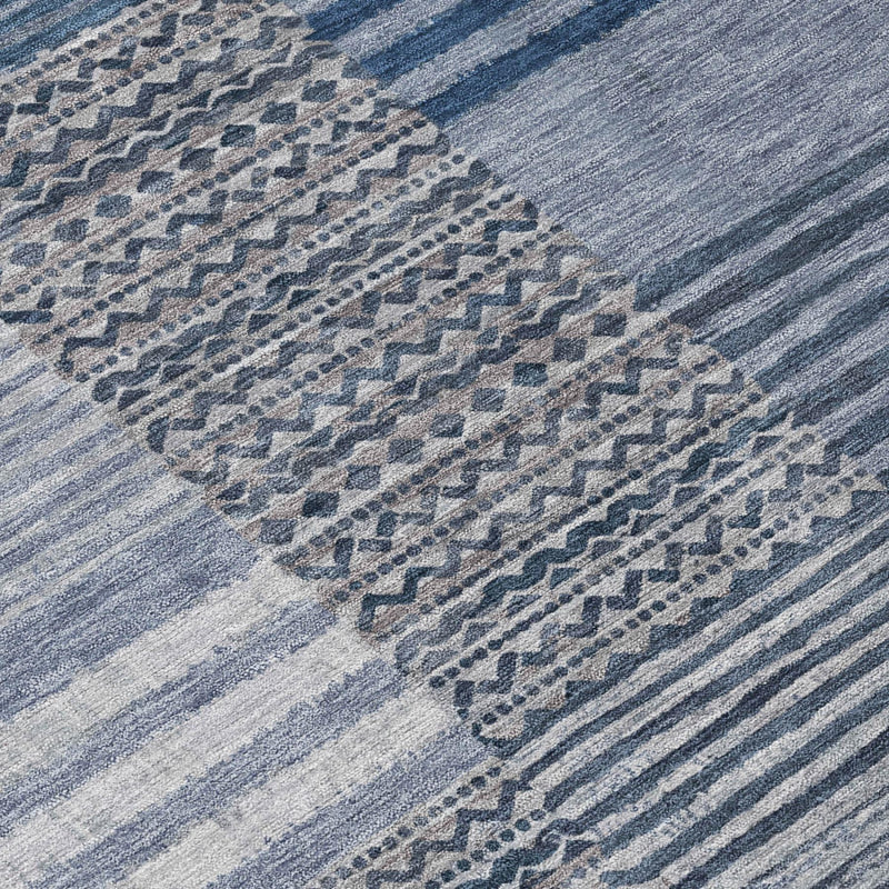 Blue and gray striped area rug with repeating dotted medallion and woven texture