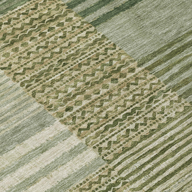 Detail of green and sage rug with geometric medallion motifs and stripe accents