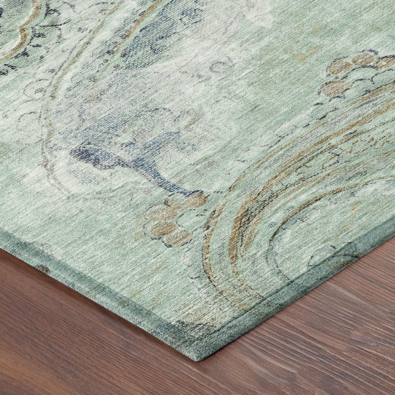 Corner of aqua and teal paisley area rug with distressed scroll border