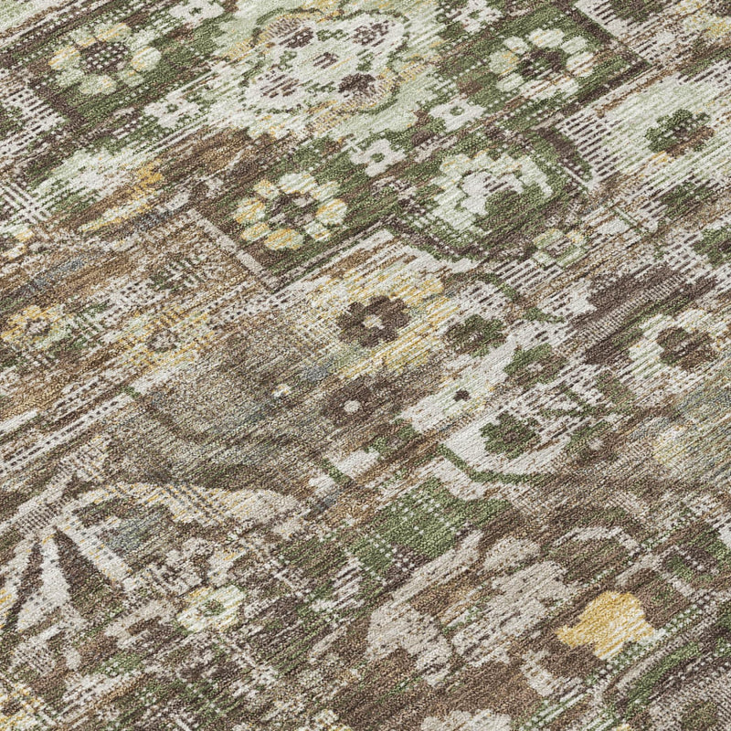 Brown area rug close-up with distressed medallion florals and green accents