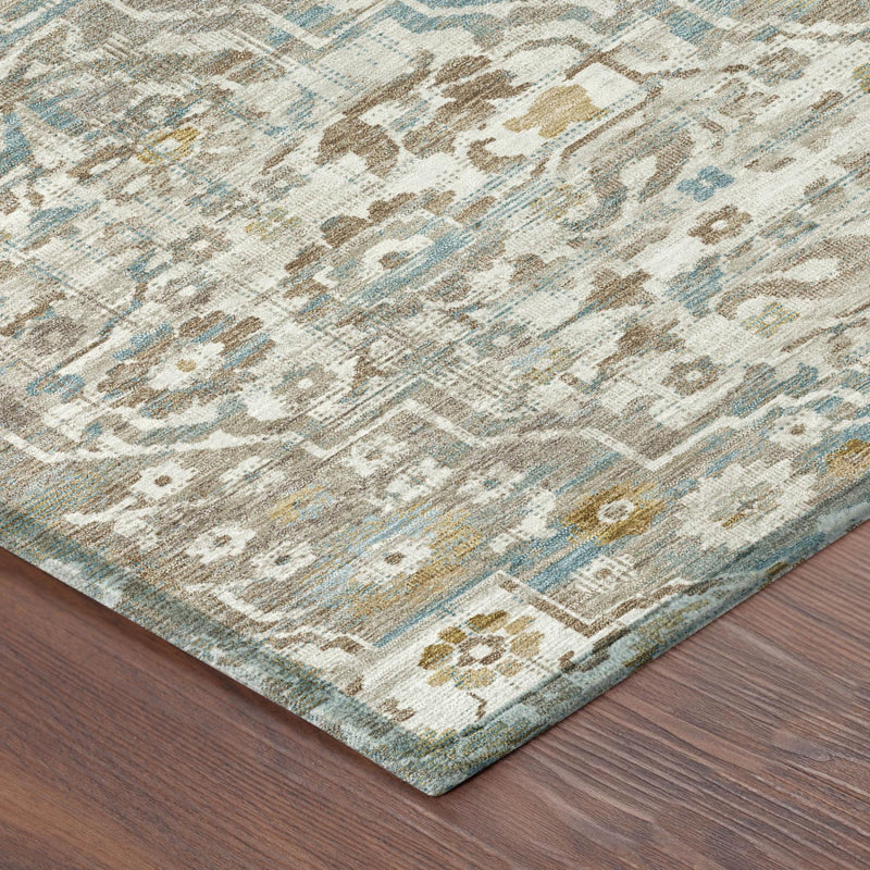 Corner of ivory and pewter rug with blue geometric floral pattern and border