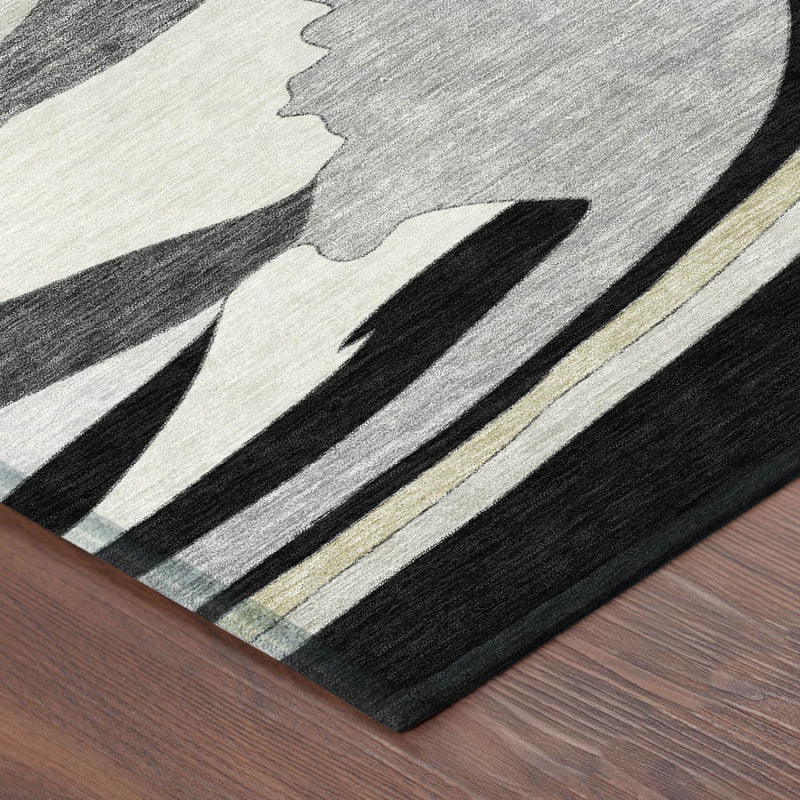 Abstract area rug close-up, black and gray with light beige textured wave shapes