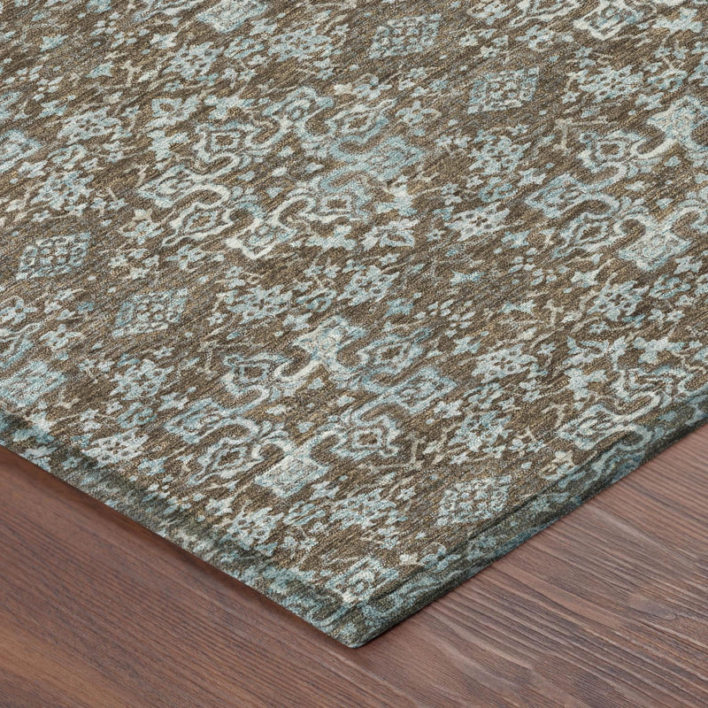 Rug corner detail with teal and brown damask pattern on a tan background