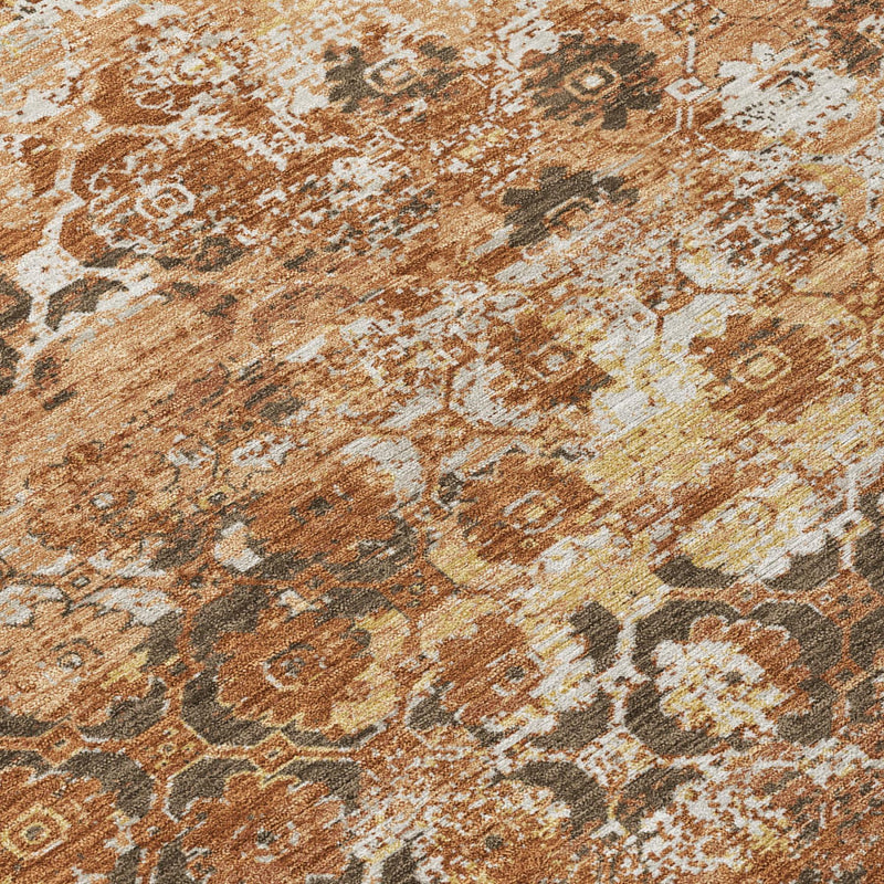 Close-up floral medallion area rug in orange-rust, cream, and dark brown tones