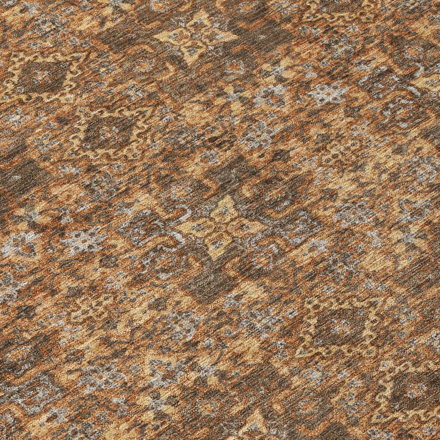 Close-up of orange, brown, and gray damask rug pattern with distressed texture