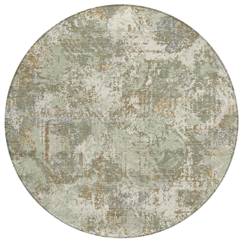 Round abstract area rug in muted green and beige, distressed speckled surface