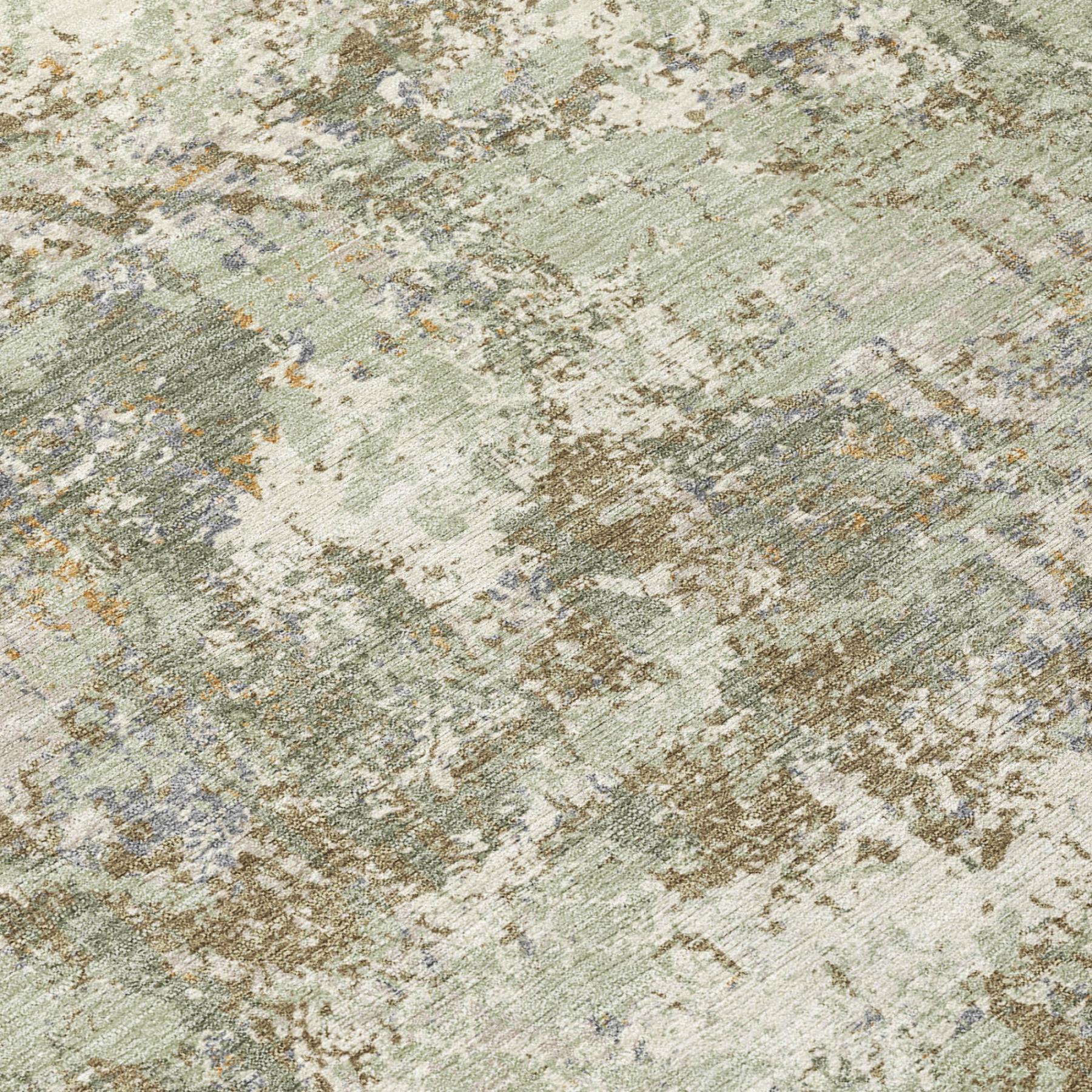 Close-up of abstract rug texture in muted green and beige, distressed mottled pattern