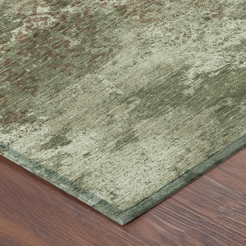 Olive green abstract area rug corner detail with short woven texture and dark edge