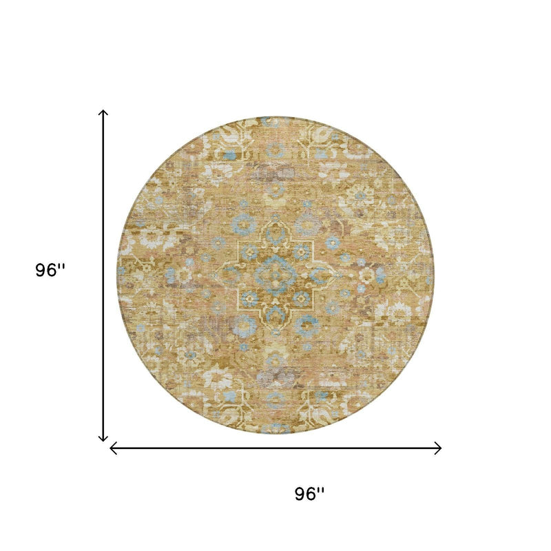 Round area rug in gold and copper with floral medallion pattern and light blue accents