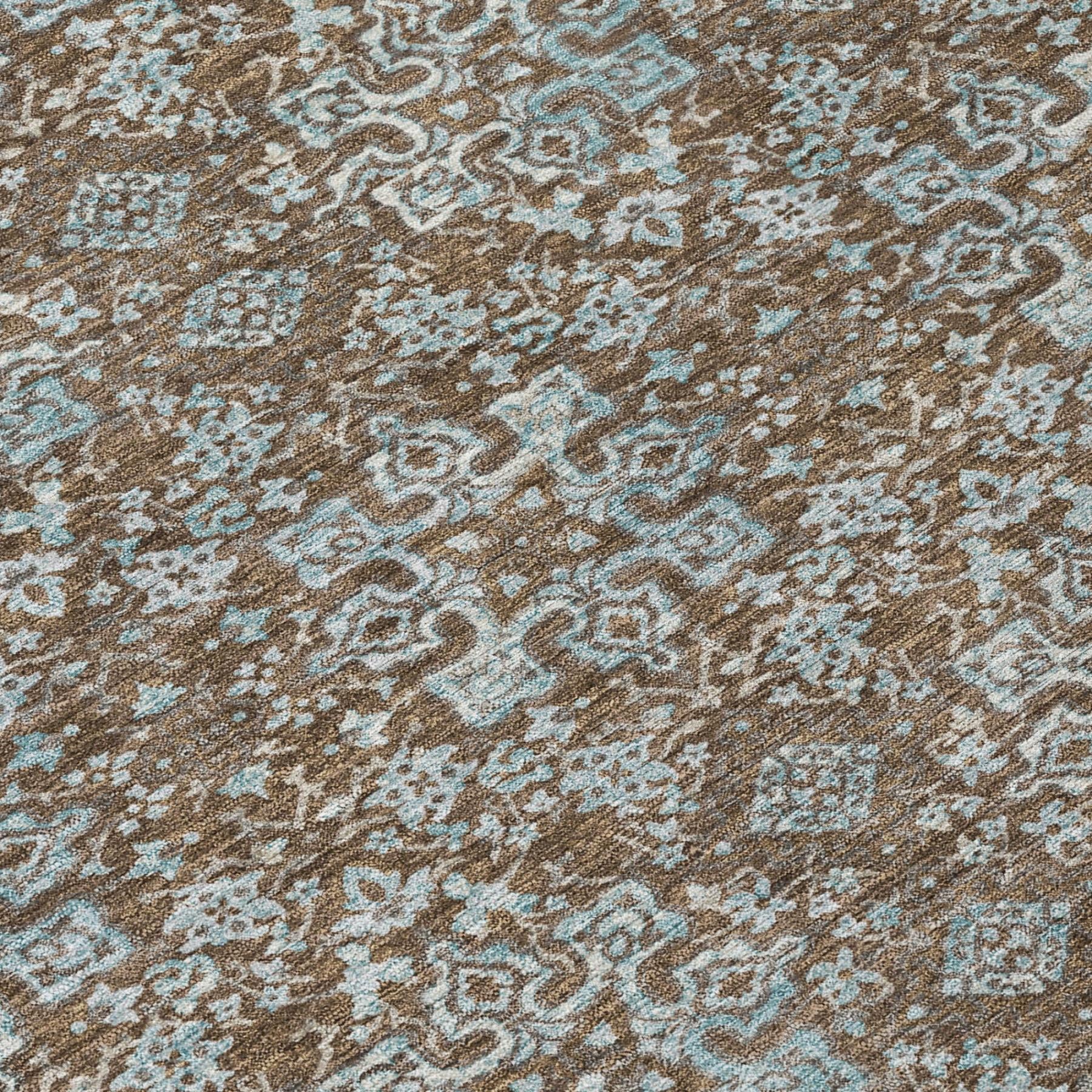 Brown and teal damask area rug with detailed scrolling medallion pattern, close-up