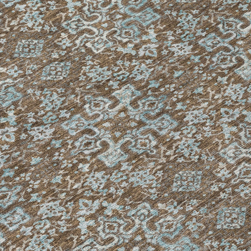 Brown and teal damask area rug with detailed scrolling medallion pattern, close-up