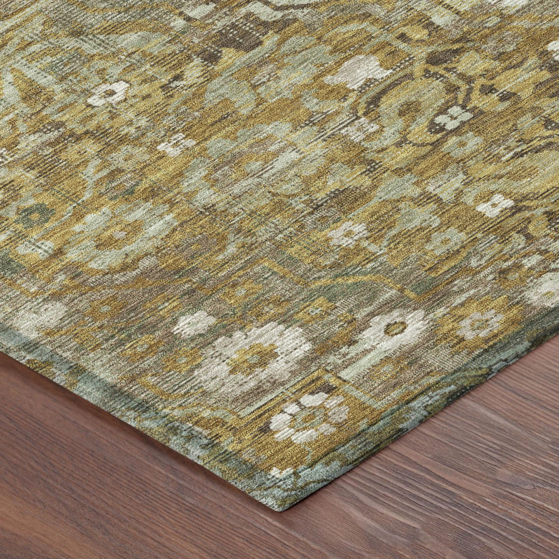 Rug corner detail with distressed floral motifs in gold and tan on a cream base