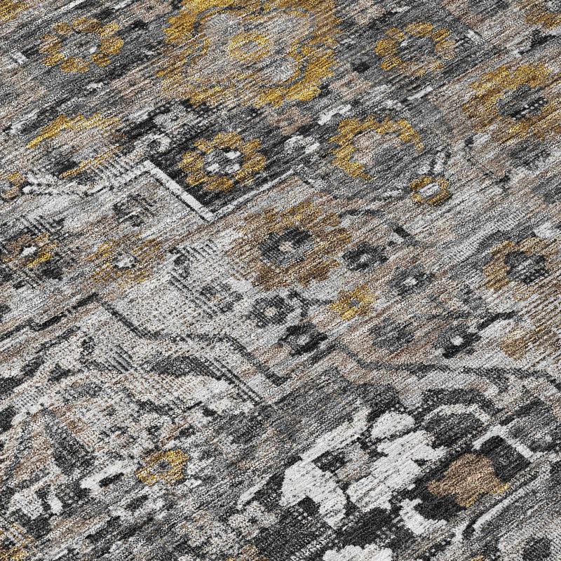 Gray and black distressed medallion rug with small gold highlights, close-up