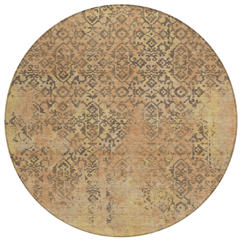 Round area rug with faded abstract medallion pattern in tan, copper, and rust