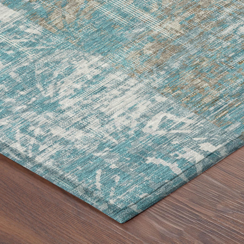 Teal blue area rug corner with distressed abstract motif