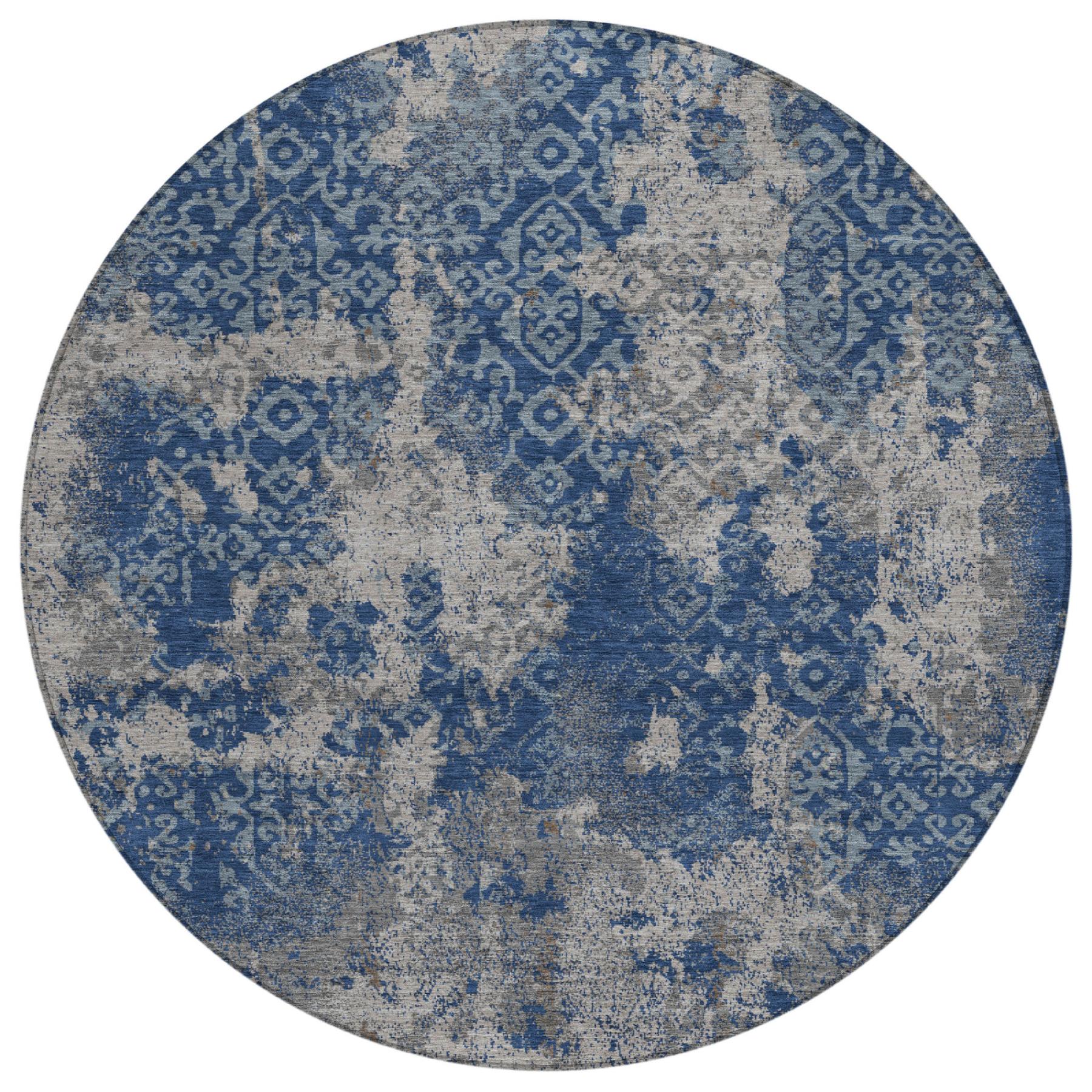 Round abstract area rug with blue motif pattern on light gray base