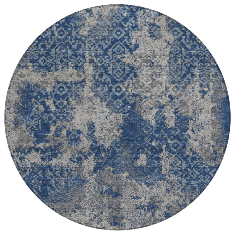 Round abstract area rug with blue motif pattern on light gray base