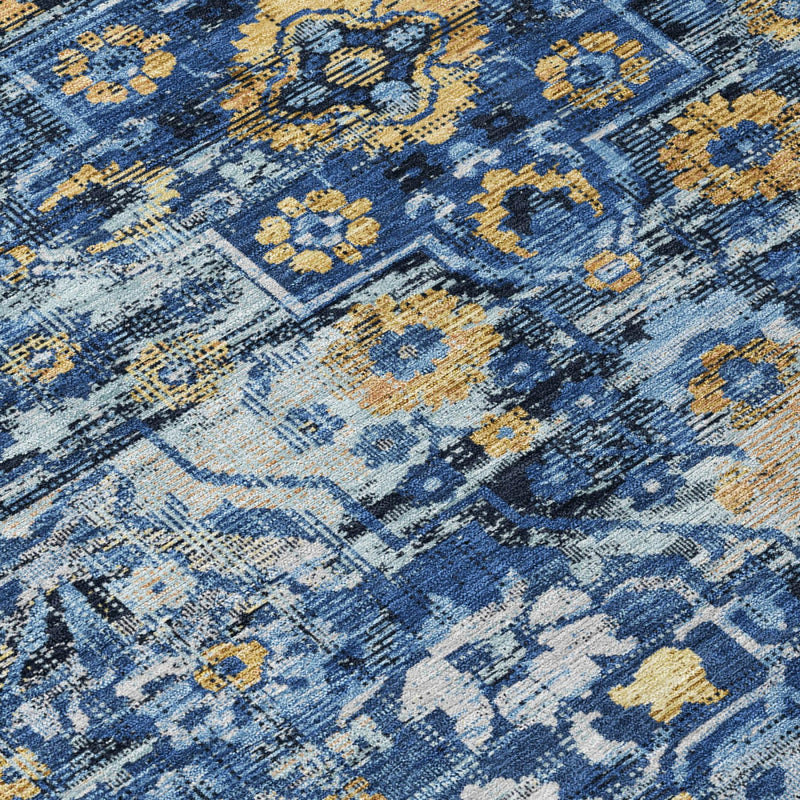 Close-up of blue and navy medallion floral rug pattern with yellow accents