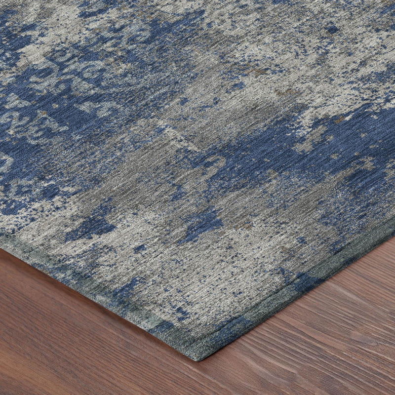 Corner view of abstract area rug in navy and light blue distressed textured finish
