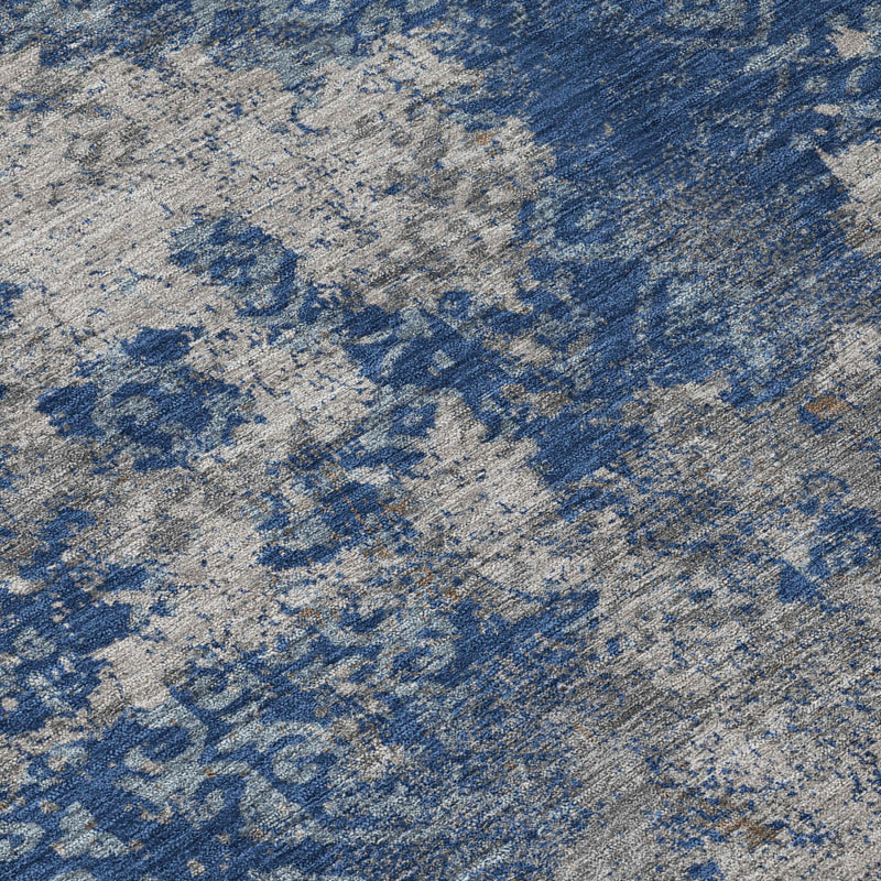 Close-up abstract area rug texture with navy and light blue distressed design
