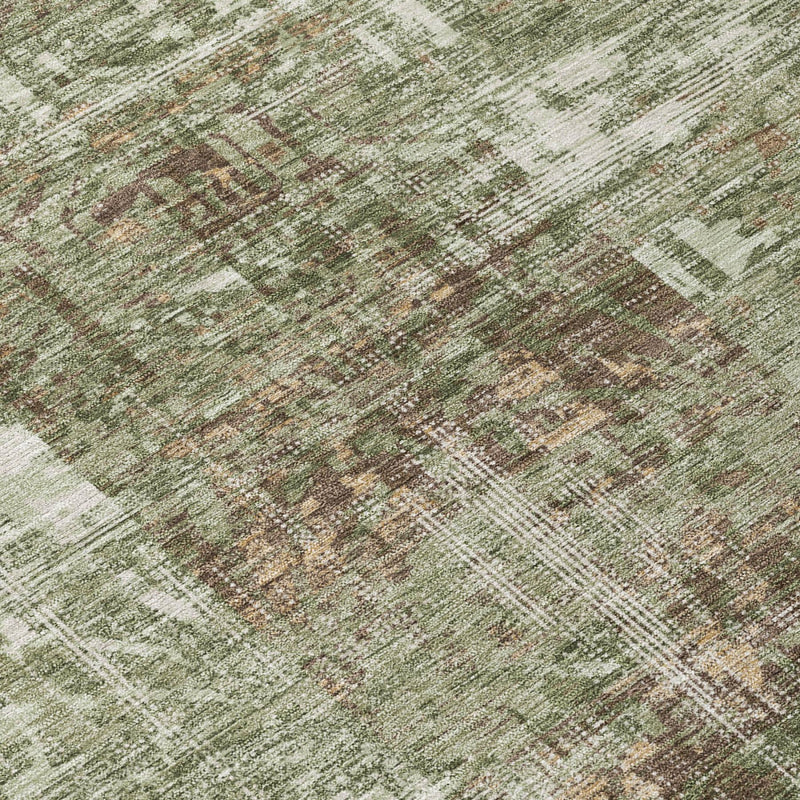 Close-up of round rug surface with distressed abstract pattern in olive green and tan