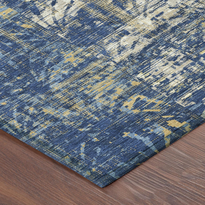 Blue abstract area rug with cream and mustard accents and distressed, textured surface.