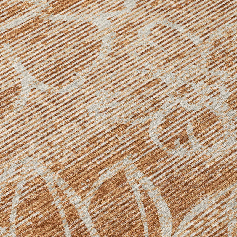 Orange and rust floral rug close-up with distressed lines and texture