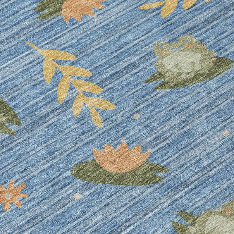 Close-up of blue rug with botanical leaves pattern in olive green and tan
