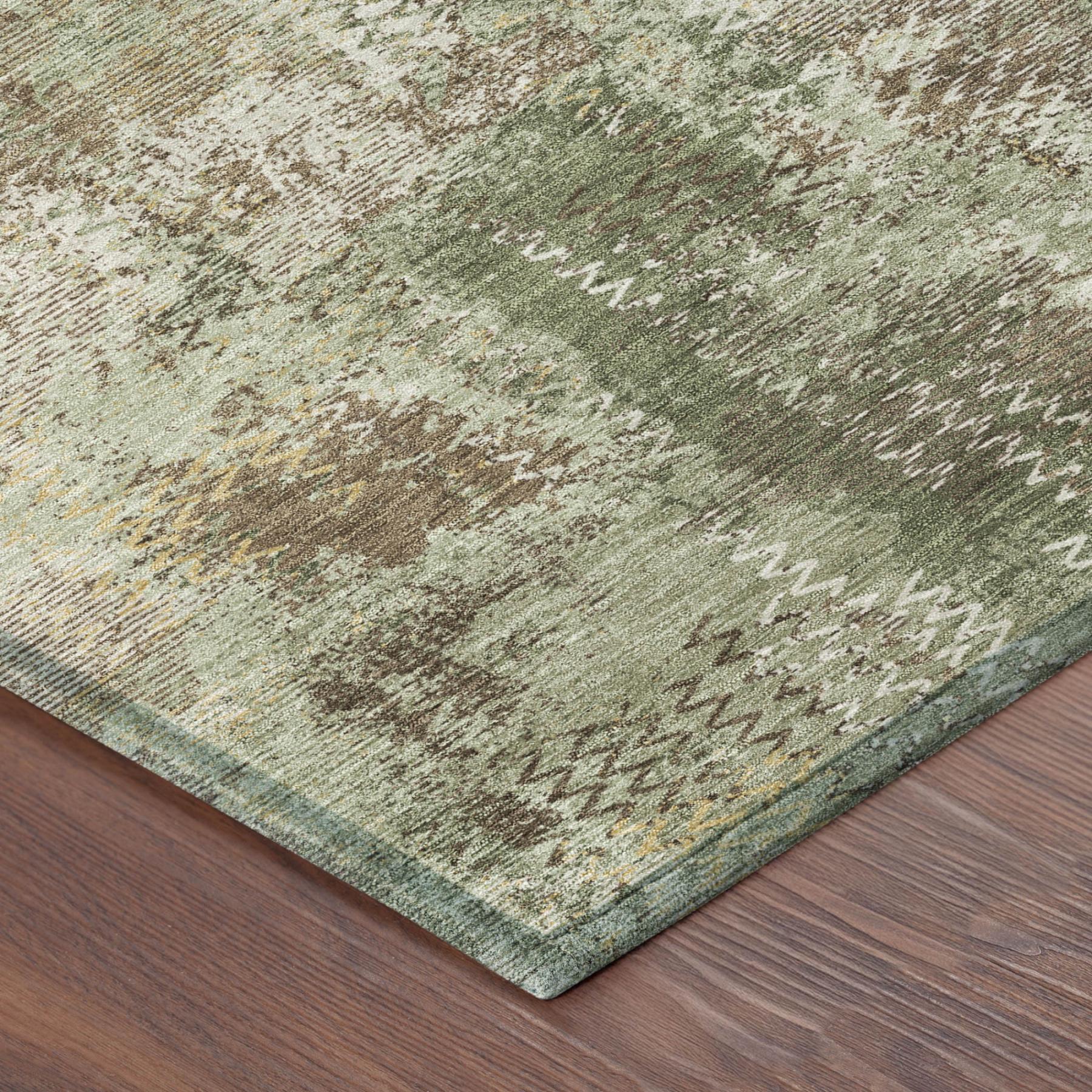 Close-up of olive green abstract area rug with mottled distressed texture.