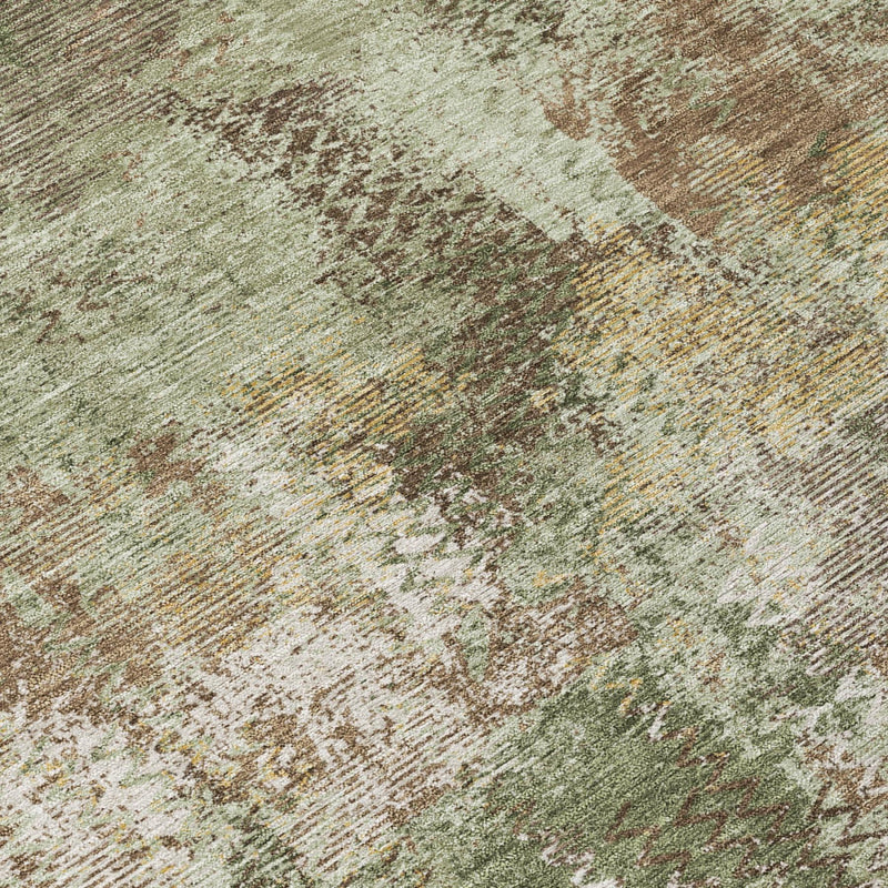 Olive green abstract area rug close-up, speckled washed effect and texture.