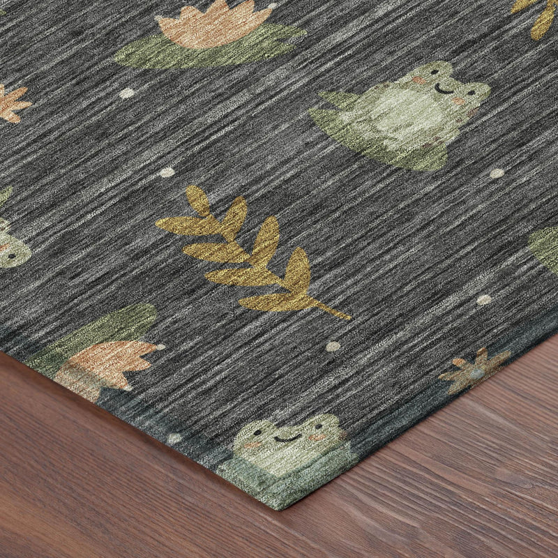 Botanical area rug corner with dark charcoal base and leaf, bunny, and acorn motifs.